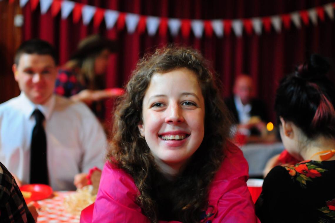 Girl smiling in hall.